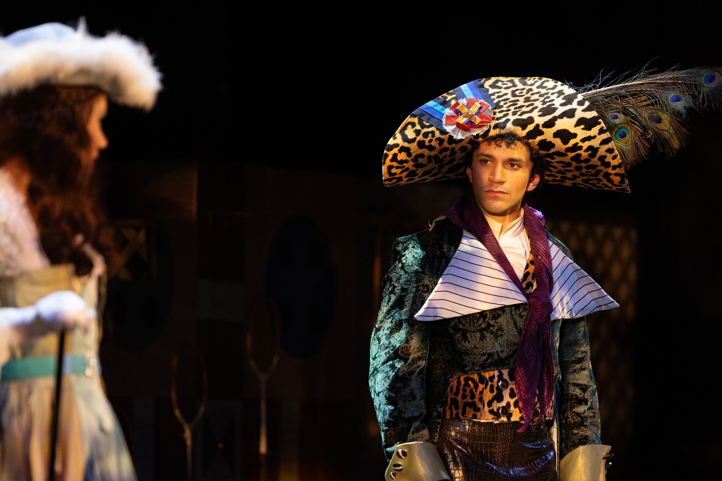Kiran Behr as Percy Blakeney in The Scarlet Pimpernel, wearing an ornate feathered hat